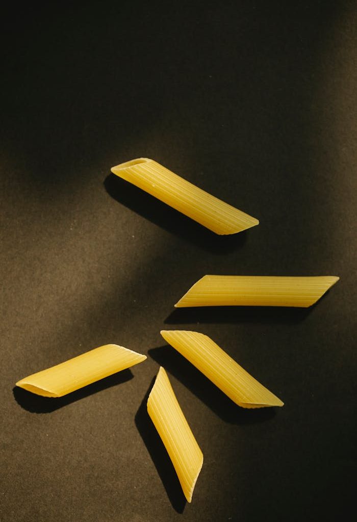 Uncooked pasta on black surface